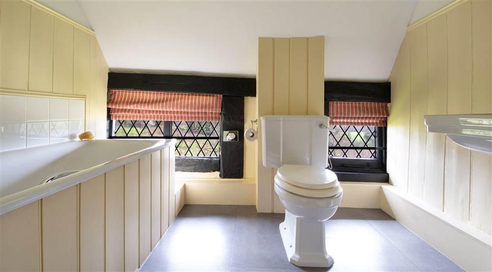 The bathroom that accommodates the double bedroom and first and second twin bedrooms at Emley Farmhouse in Godalming, Surrey