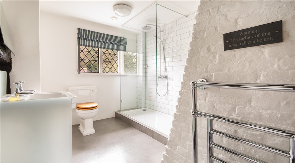 The main bedroom en-suite shower room at Emley Farmhouse in Godalming, Surrey
