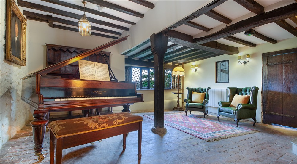 The piano room at Emley Farmhouse in Godalming, Surrey