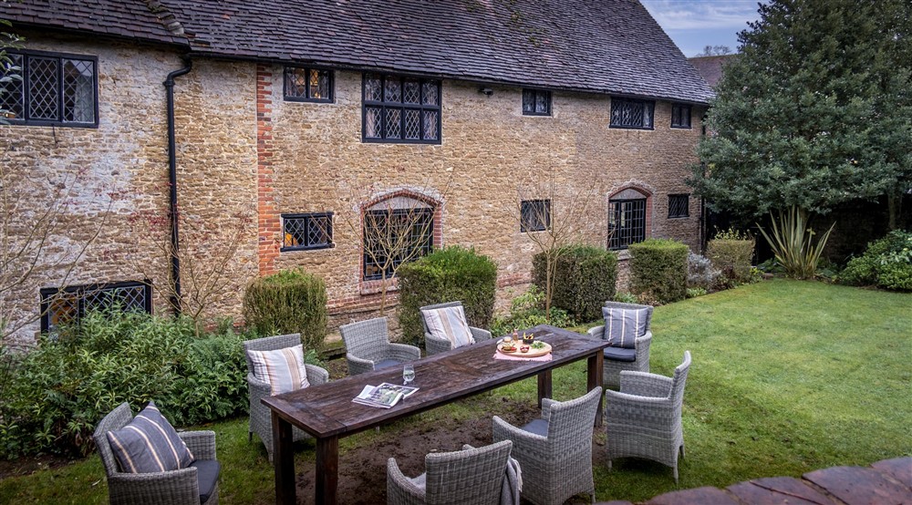 The rear exterior and outdoor furniture at Emley Farmhouse in Godalming, Surrey