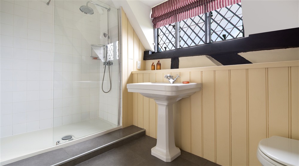 The shower room that accommodates the third twin bedroom at Emley Farmhouse in Godalming, Surrey