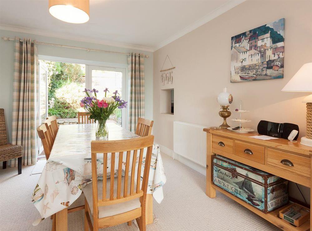 Dining area with patio doors to rear terrace and garden at End House in Coronation/Forster, Devon