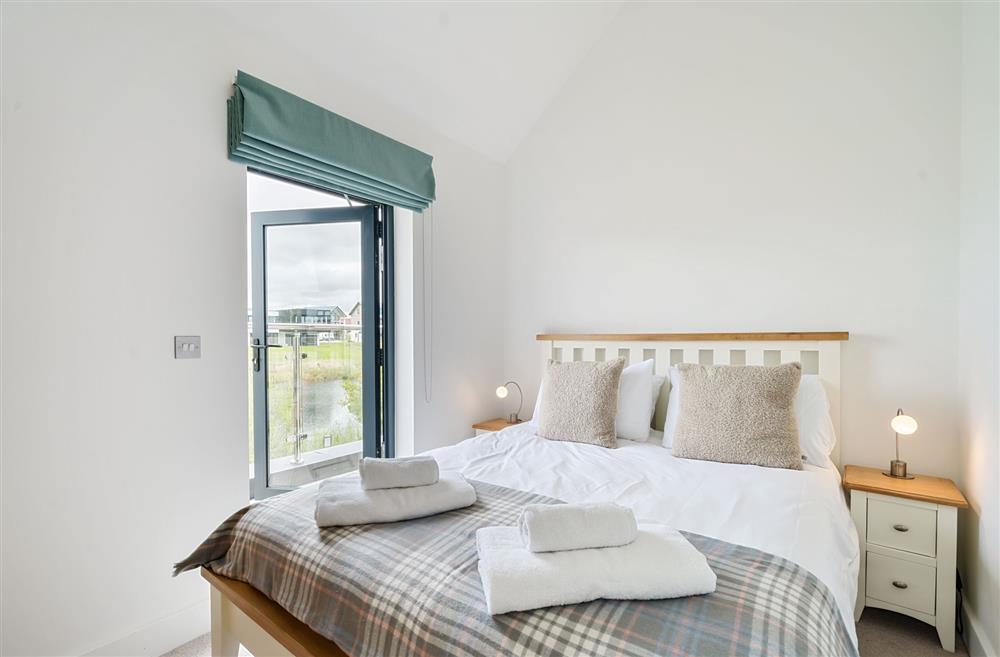 Bedroom two, with balcony access and a 4’6 double bed at Equinox, Dorchester