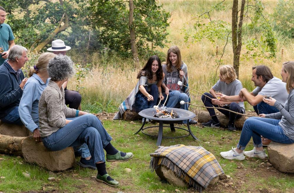 A family sat around the fire pit