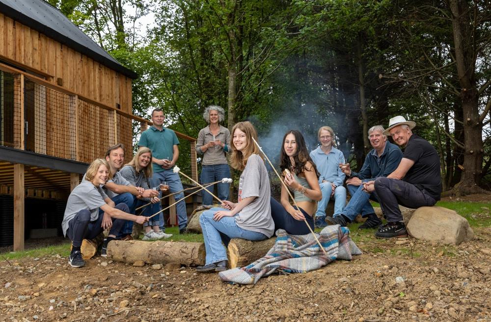 A family sitting around the fire pit