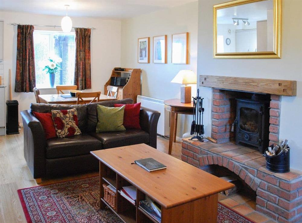 Comfortable living area and dining table and chairs at Erskine Cottage in Seahouses, Northumberland