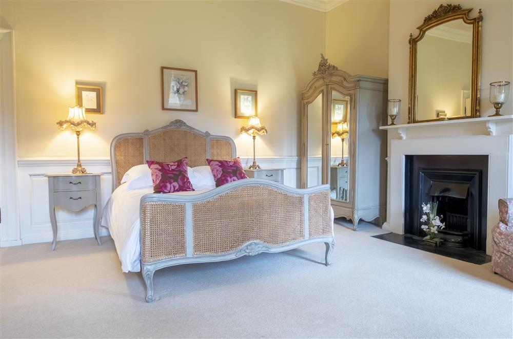 Bedroom five boasts a beautiful decorative fireplace at Eslington East Wing, Alnwick