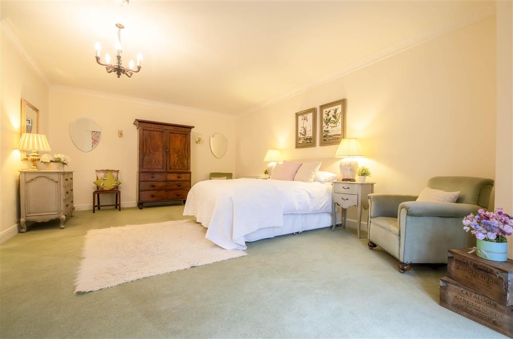 Spacious bedroom one with a 6’ super-king size bed at Eslington Lodge, Alnwick