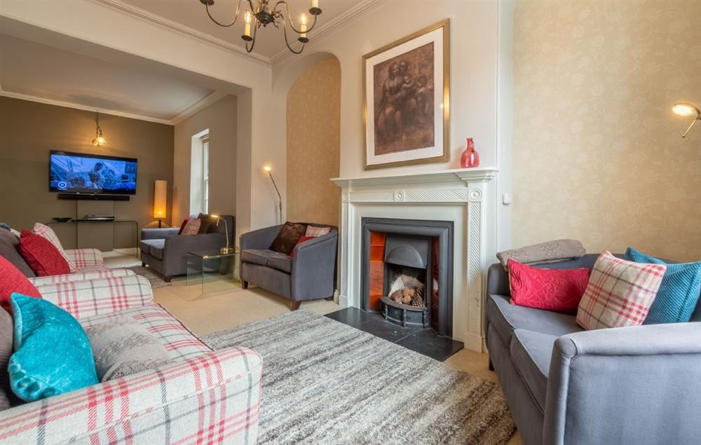 Large sitting room with Smart television and open fire at Estcourt House, Burnham Market