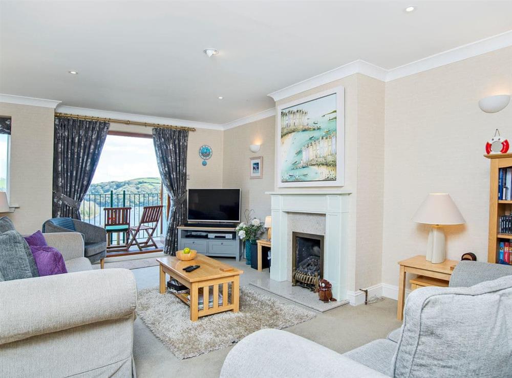 Welcoming living room with French doors leading to balcon at Estuary Heights in Fowey, Cornwall