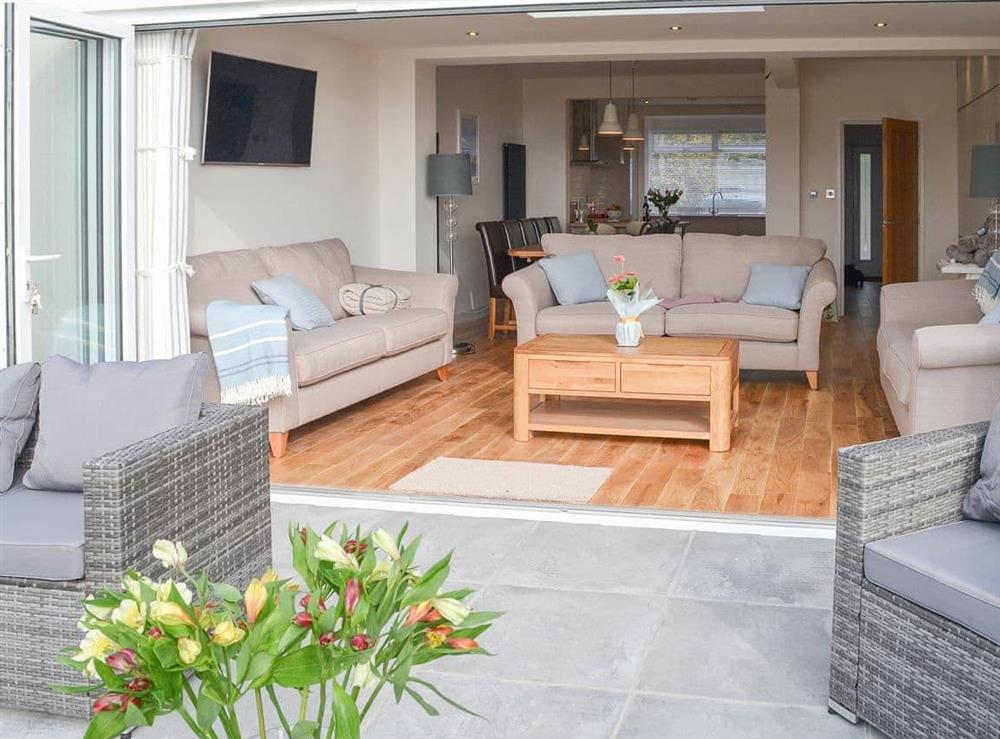 Bi-fold doors make the terrace and the living area one beautiful space at Estuary View in Exmouth, Devon