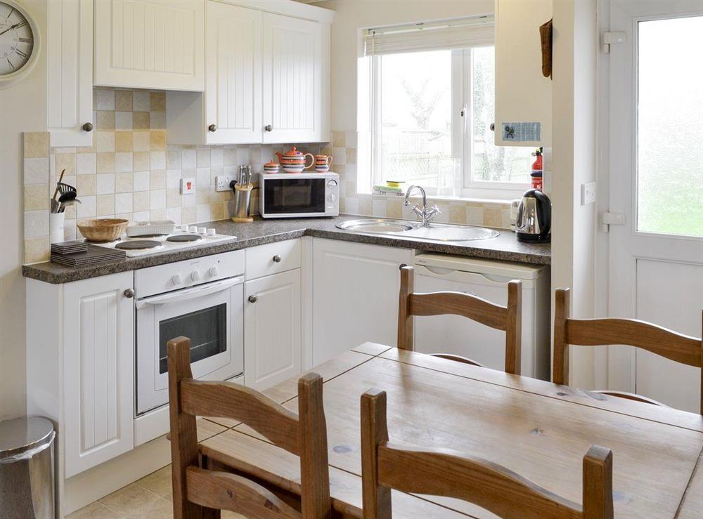 Well-equipped kitchen with convenient dining area at Evelyn in Port Isaac, Cornwall