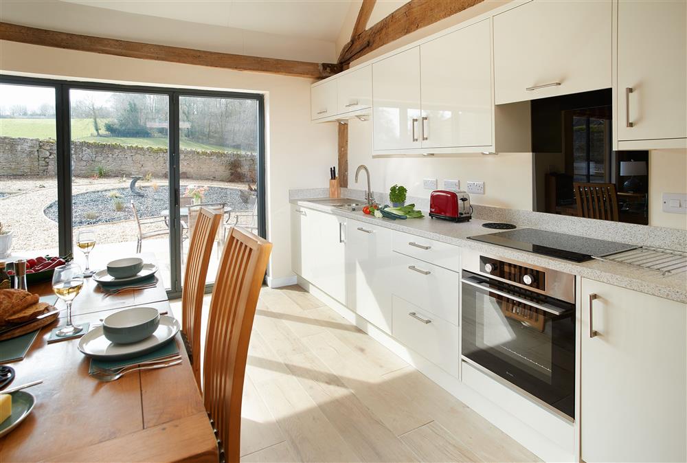 Evenwood Gables, Shropshire: Fully-equipped kitchen with bi-folding doors leading to the patio at Evenwood Gables, Acton Burnell, Shrewsbury