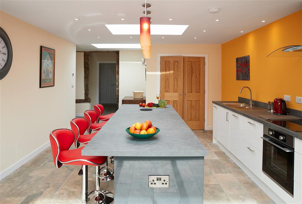Evenwood Granary, Shropshire: Kitchen with sit-up island with four stools at Evenwood Granary, Acton Burnell, Shrewsbury