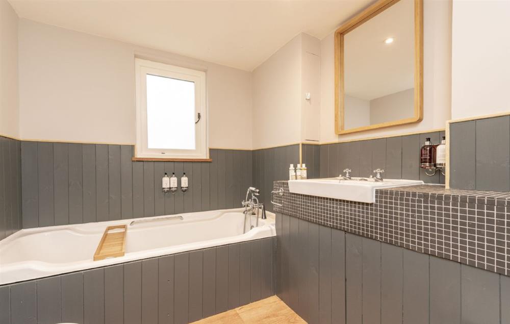 Bathroom with bath and shower over at Evergreen, Bransgore