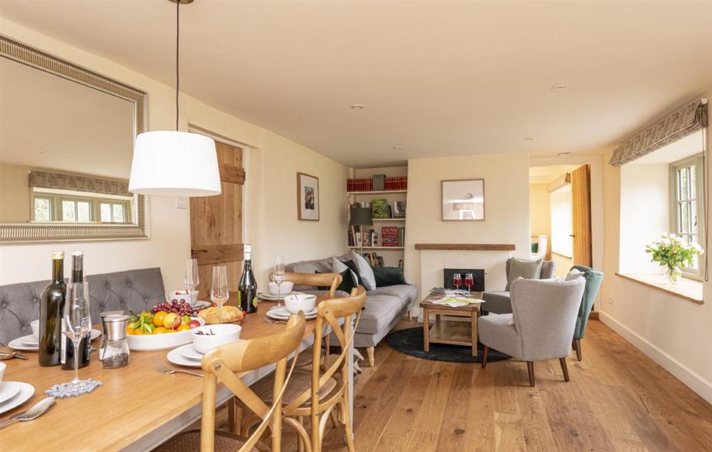 Open-plan dining area leading to seating area with fire at Evergreen, Bransgore