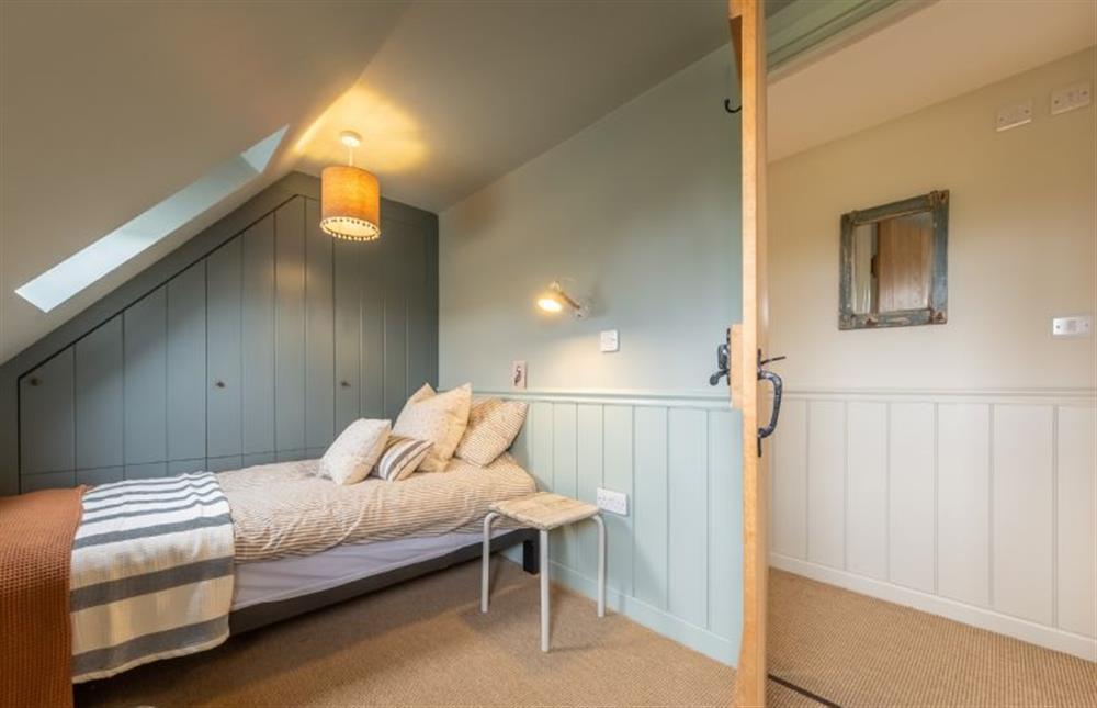 First floor: Bedroom three with a single bed to each side of the room at Evergreen, Thornage near Holt
