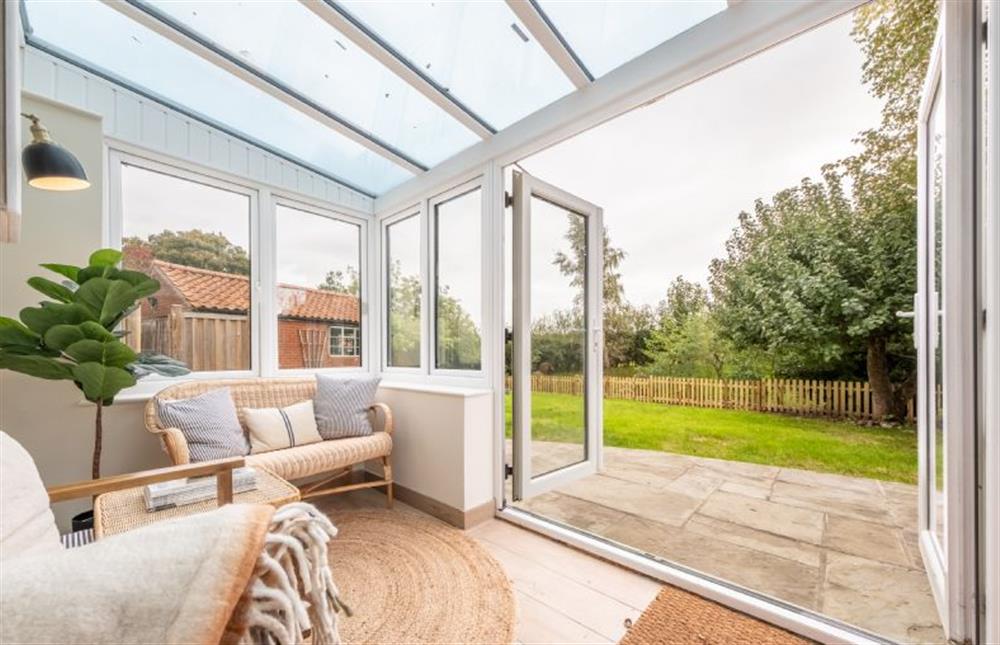 Ground floor: Double doors open to the patio and garden at Evergreen, Thornage near Holt