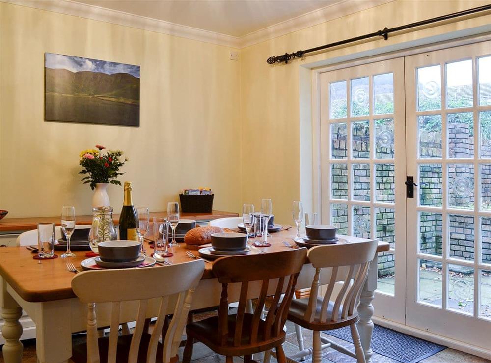 Dining area with French doors to the garden at Fairfield in Keswick, Cumbria