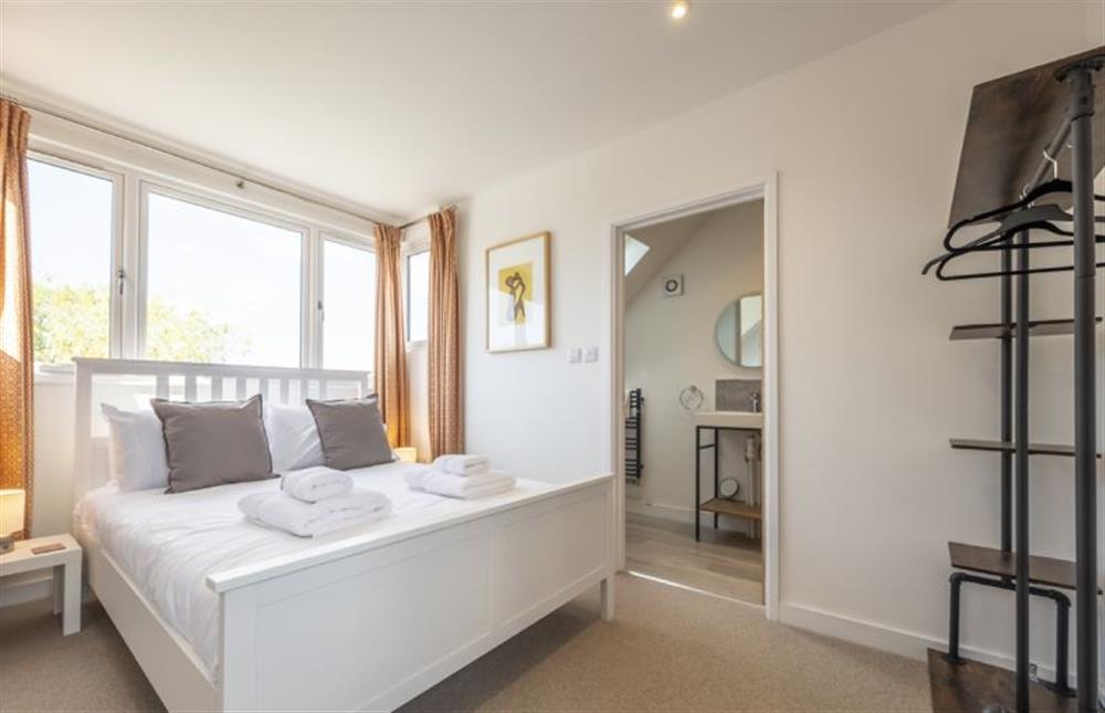 Bedroom two with a 5’ king-size bed and views towards the coastline at Fairway, Old Hunstanton
