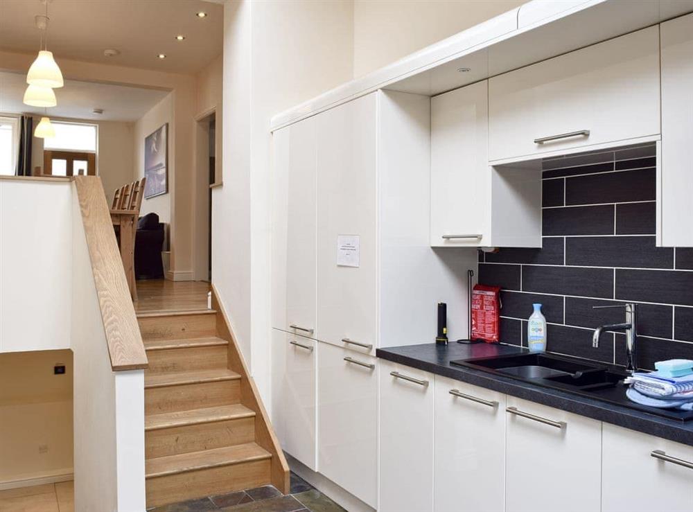 Fitted kitchen with stairs down to lower level at Falcon Crag** in Keswick, Cumbria