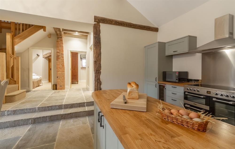 Open plan fully equipped kitchen, snug and dining table seating seven guests (photo 3) at Fallow Folly, Little Massingham