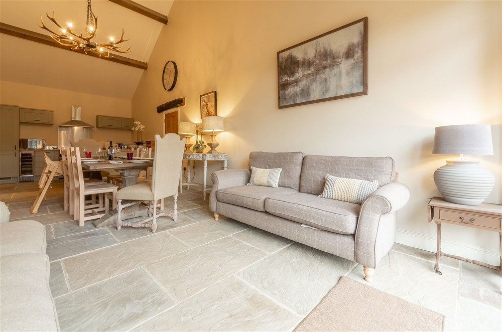 Snug, dining area and kitchen with hand-made deer antler chandelier at Fallow Folly, Little Massingham