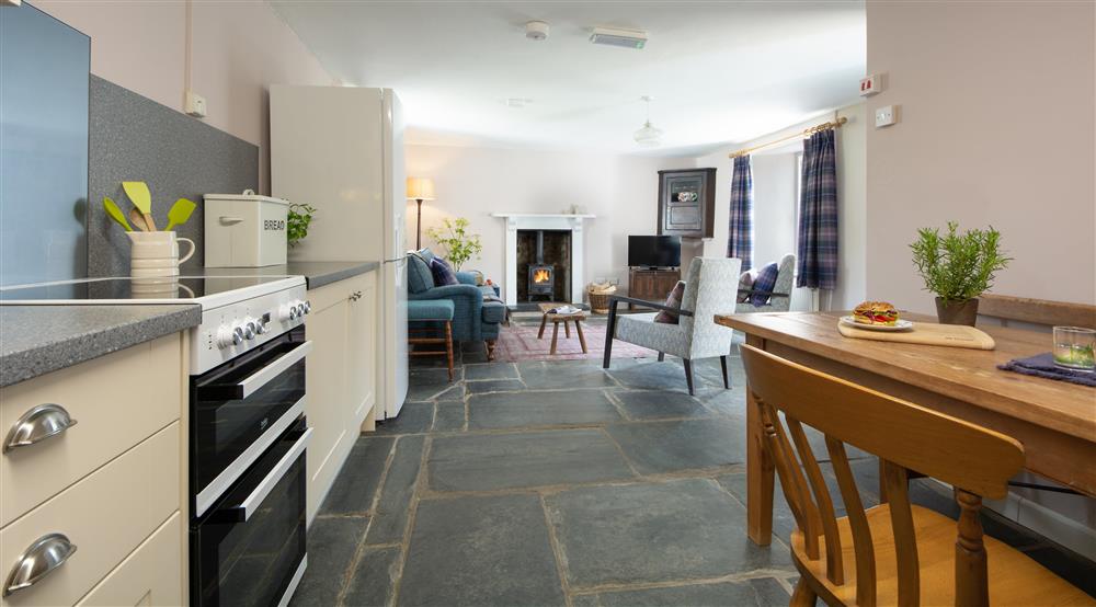 The dining kitchen and sitting room at Farm Cottage in Pembroke, Pembrokeshire