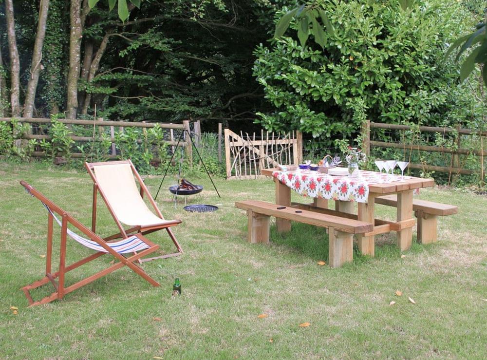 Garden area with outdoor furniture at Farmer Oaks Hut in Dippertown, near Tavistock, Devon