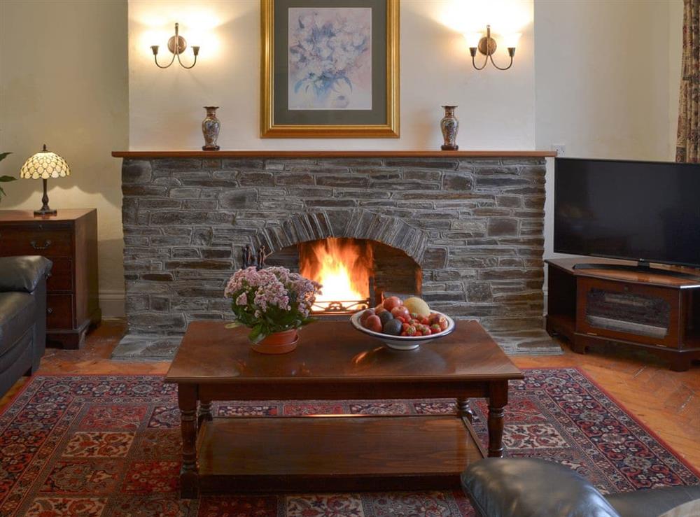 Cosy living room with open fire at Farmhouse in Lostwithiel, Cornwall