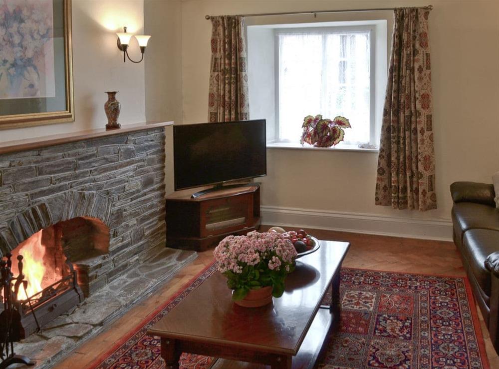 Living room with open fire (photo 2) at Farmhouse in Lostwithiel, Cornwall