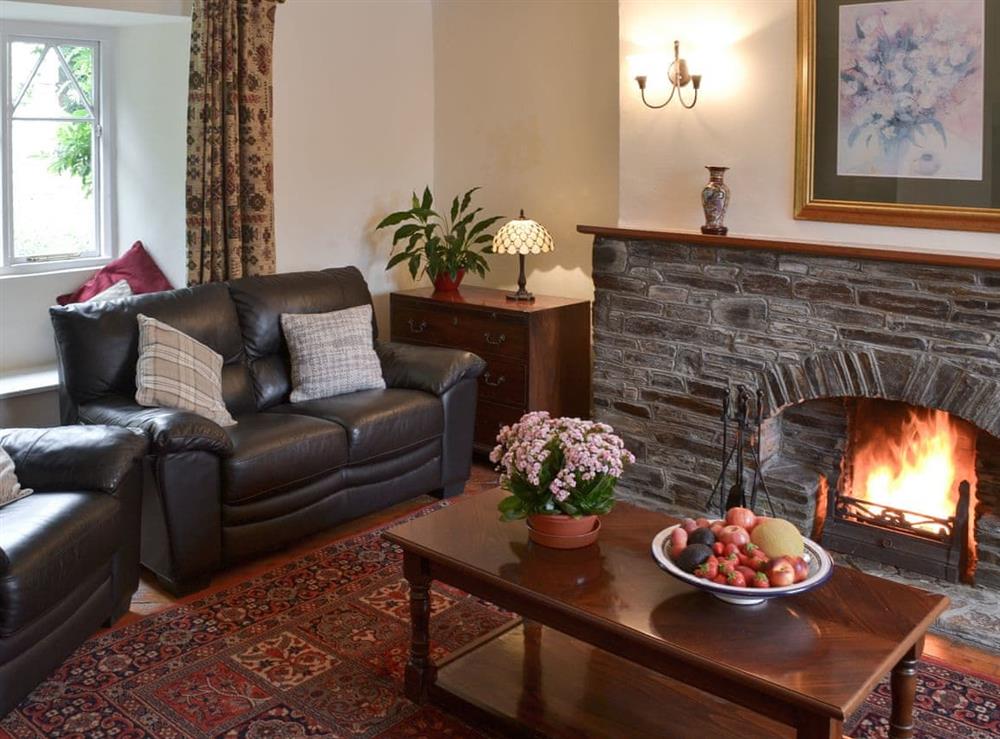 Living room with open fire at Farmhouse in Lostwithiel, Cornwall