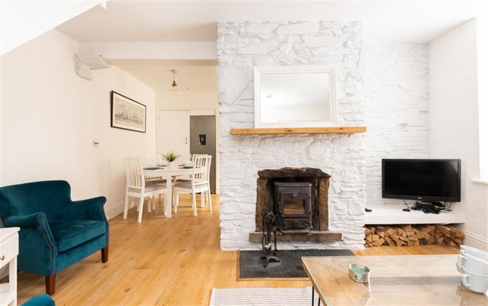 Sitting area with wood burning stove and smart TV at Farriers Cottage, Chipton Barton in Dittisham