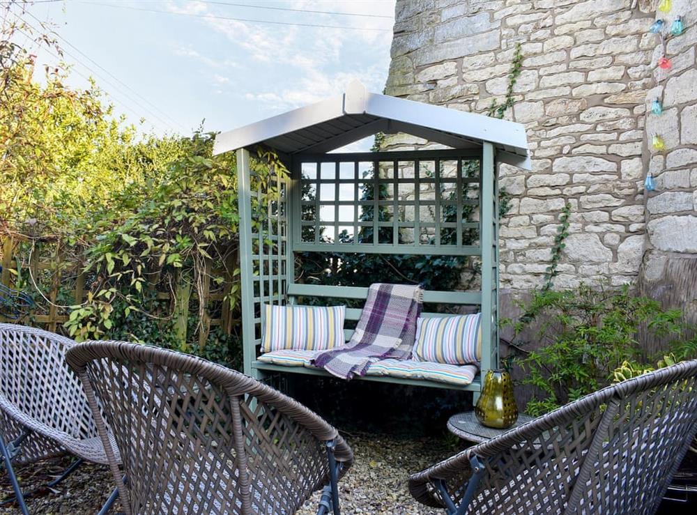 Terraced garden with sitting-out area and garden furniture at Farview in Selsley, near Stroud, Gloucestershire