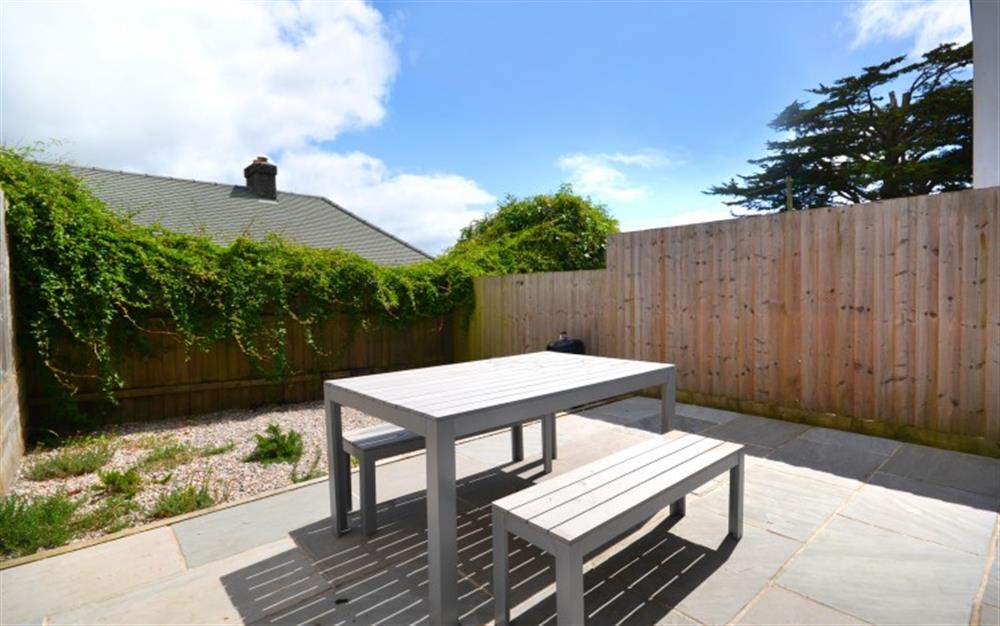 The enclosed garden with smart furniture and barbecue at Fastnet in Salcombe