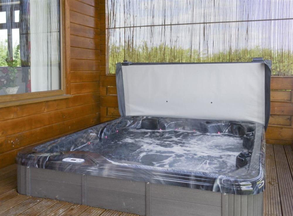 Luxurious sunken hot tub on veranda at Bramble Lodge, 