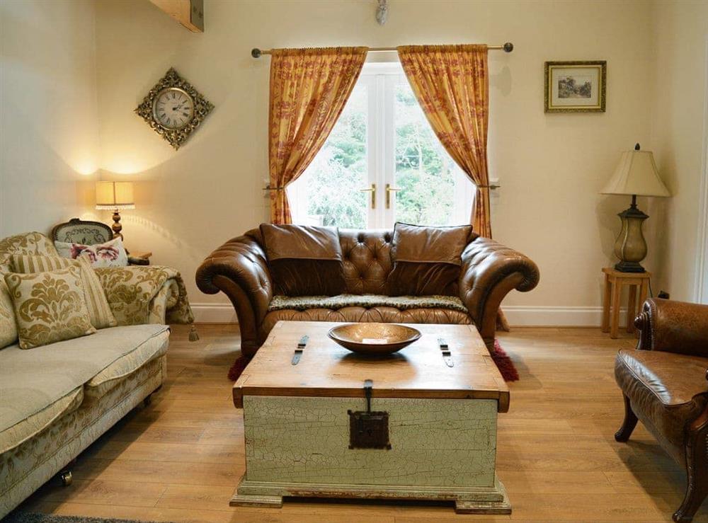 Elegant beamed living room with wood-burning stove at Faws House in Thrunton, Alnwick., Northumberland