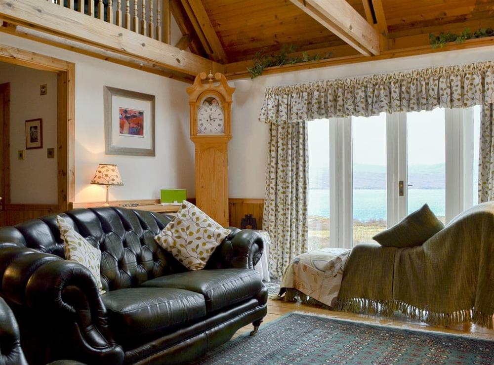 Living room with chaise longues positioned perfectly in front of the huge window framing the Torridon range at Fearnmore Church in Fearnmore, near Applecross, Ross-Shire