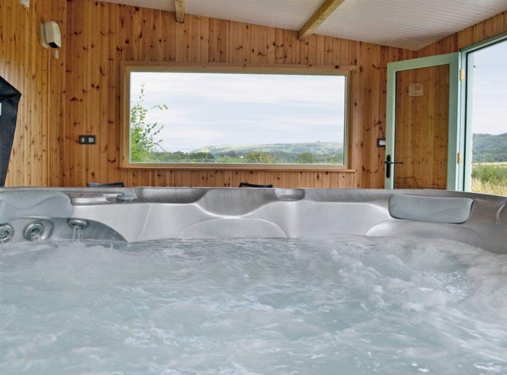 Enjoy a soak in the hot tub at Felin Hedd in Tregaron, near Aberystwyth, Dyfed