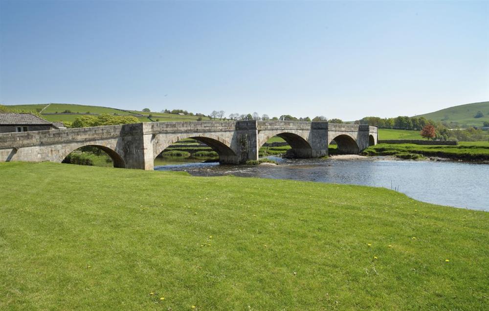 The 16th century stone bridge straddling the River Wharfe at Fell Beck, Burnsall