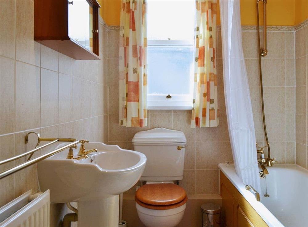 The bright and sunny bathroom has a shower over the bath at Fellside in Keswick, Cumbria