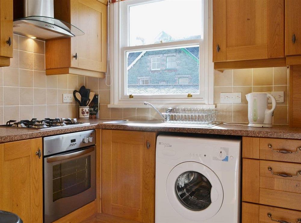 The kitchen is well organised and has lovely wooden units at Fellside in Keswick, Cumbria