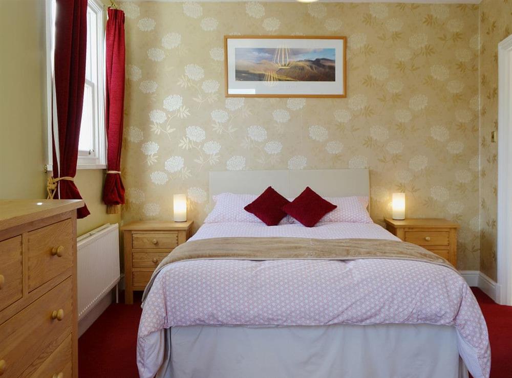 The master bedroom is well decorated and has an en suite shower room at Fellside in Keswick, Cumbria