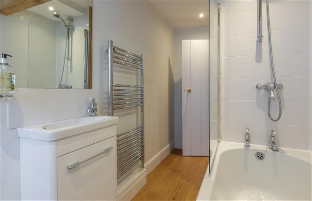 Bathroom with bath and shower over at Fenwick Cottage, Higham