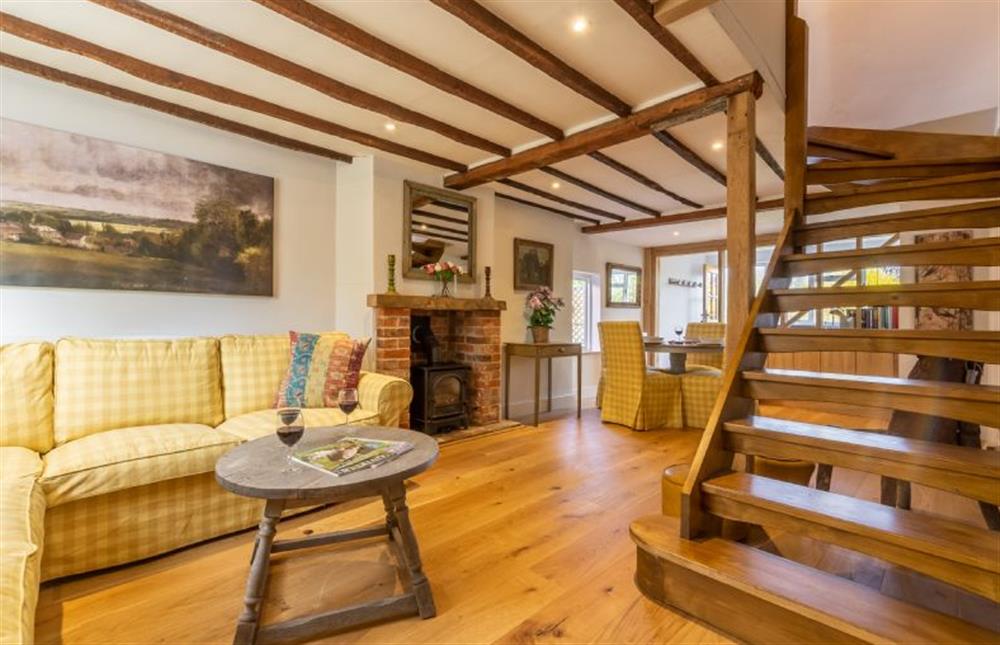 Open-plan living space with stairs to first floor at Fenwick Cottage, Higham
