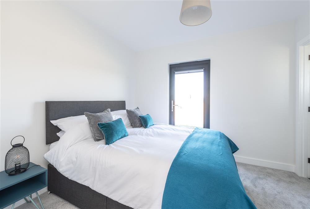 Bedroom one with a 5ft king-size bed and en-suite shower room at Fern, Ansty, Dorchester