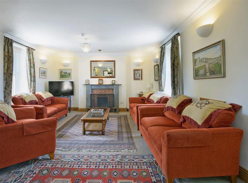 Spacious living room with open fire at Fernlea in Acton, Nr Langton Matravers, Dorset., Great Britain