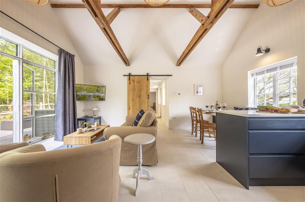 The open-plan living space boasts exposed beams at Fernwood, Rolvenden