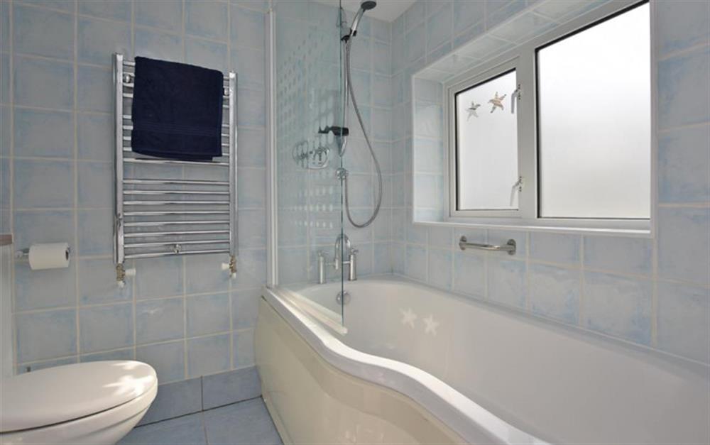 En suite bathroom with shower over bath at Ferry Cottage in Lymington
