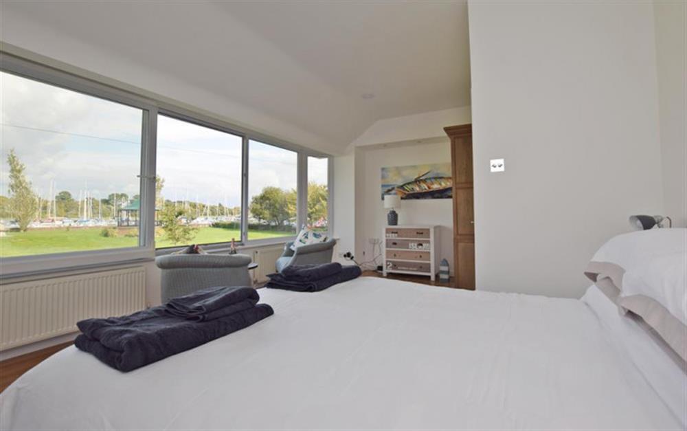 Master bedroom showing views over green and Lymington River at Ferry Cottage in Lymington